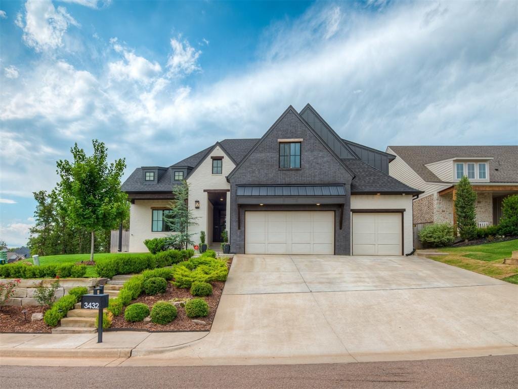 3432 Piedmont Way, Edmond, OK 73034 - craftsman house featuring stucco siding, an attached garage, and driveway