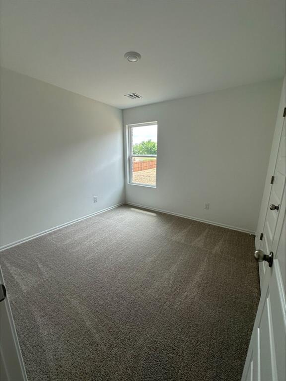 794 SW 11th St, Newcastle, OK 73065 - unfurnished room with dark carpet and baseboards