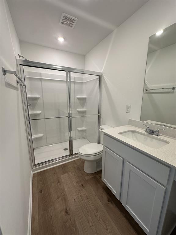 794 SW 11th St, Newcastle, OK 73065 - bathroom with wood finished floors, toilet, vanity, and a shower stall