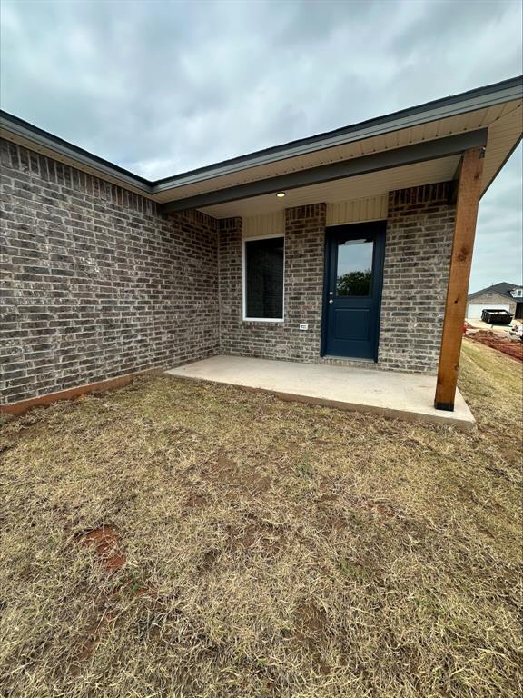 794 SW 11th St, Newcastle, OK 73065 - back of house featuring a patio and brick siding
