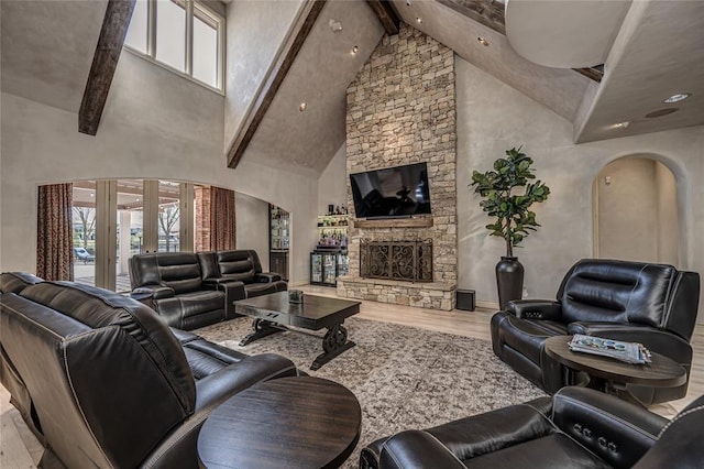 5100 Wisteria Dr, Oklahoma City, OK 73142 - living room featuring arched walkways, wood finished floors, beamed ceiling, and plenty of natural light