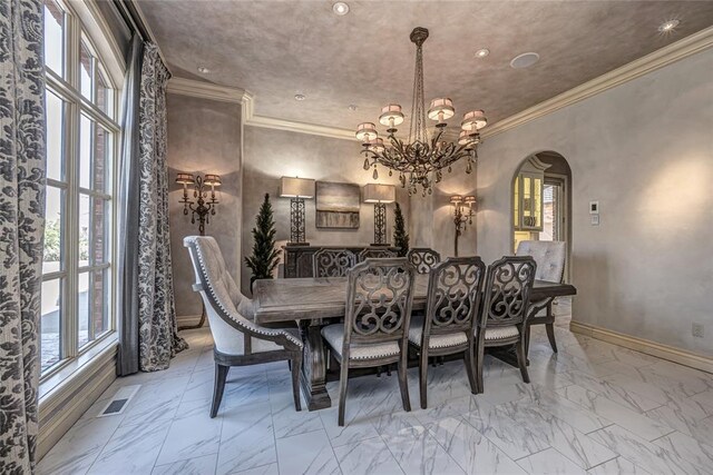 5100 Wisteria Dr, Oklahoma City, OK 73142 - dining space with a chandelier, arched walkways, ornamental molding, and plenty of natural light