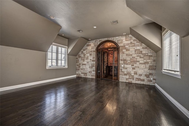 5100 Wisteria Dr, Oklahoma City, OK 73142 - additional living space featuring arched walkways, wood finished floors, and baseboards