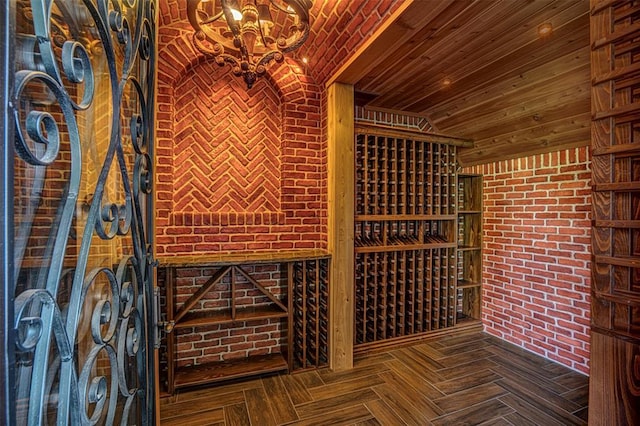 5100 Wisteria Dr, Oklahoma City, OK 73142 - wine room featuring brick wall and an inviting chandelier