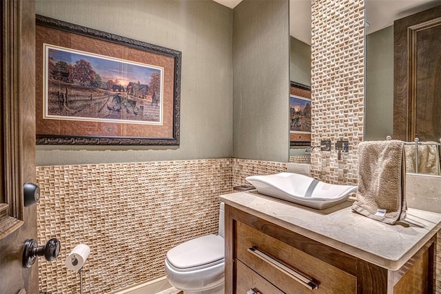 5100 Wisteria Dr, Oklahoma City, OK 73142 - half bath with toilet, vanity, and tile walls