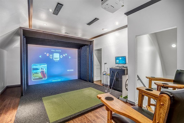 5100 Wisteria Dr, Oklahoma City, OK 73142 - home theater room featuring crown molding, wood finished floors, golf simulator, and baseboards