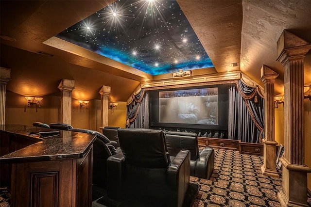 5100 Wisteria Dr, Oklahoma City, OK 73142 - home theater room with carpet flooring, visible vents, ornate columns, and a raised ceiling