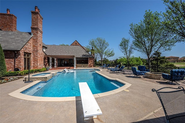 5100 Wisteria Dr, Oklahoma City, OK 73142 - view of swimming pool featuring a diving board, a pergola, a fire pit, a patio area, and a pool with connected hot tub