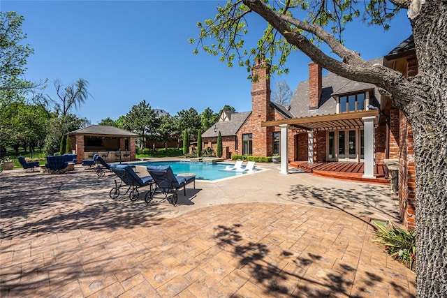 5100 Wisteria Dr, Oklahoma City, OK 73142 - view of swimming pool featuring a diving board, a gazebo, a patio area, and a pool with connected hot tub