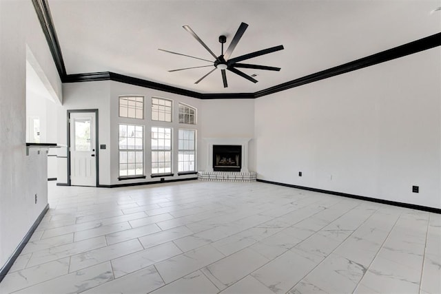 unfurnished living room featuring ornamental molding, marble finish floor, ceiling fan, and baseboards