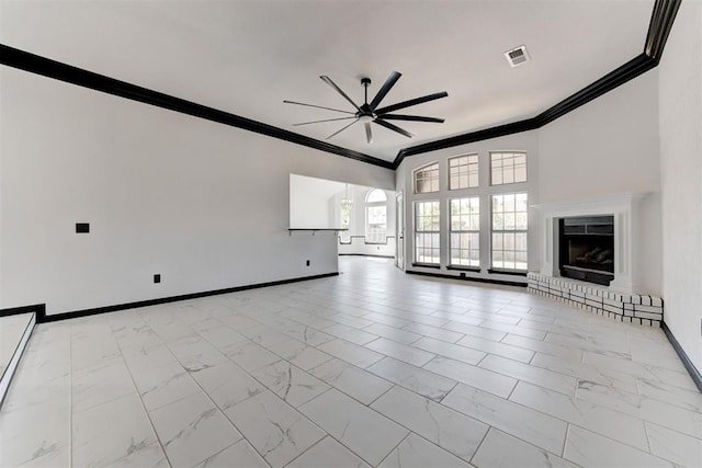 unfurnished living room with baseboards, ornamental molding, a ceiling fan, and marble finish floor