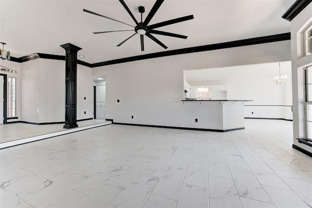 unfurnished living room featuring crown molding, marble finish floor, decorative columns, and baseboards