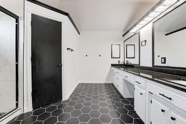 full bath featuring double vanity, a shower, tile patterned flooring, and a sink