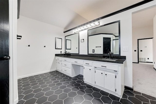 full bathroom featuring tile patterned floors, double vanity, vaulted ceiling, a sink, and visible vents