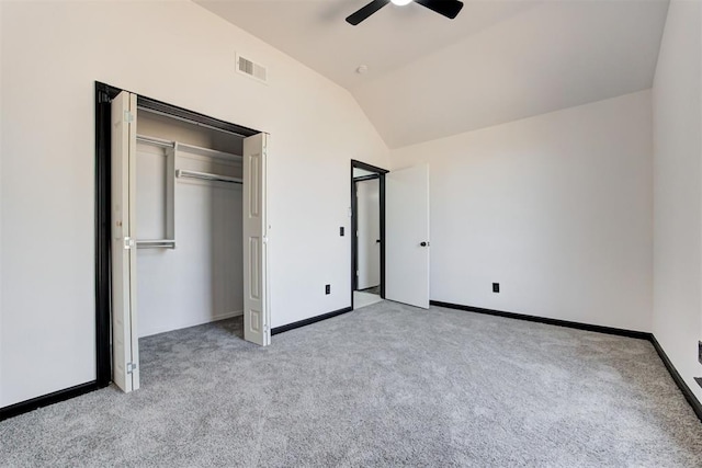 unfurnished bedroom featuring baseboards, visible vents, light colored carpet, and vaulted ceiling