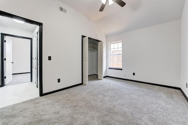 unfurnished bedroom with lofted ceiling, visible vents, ceiling fan, baseboards, and light carpet