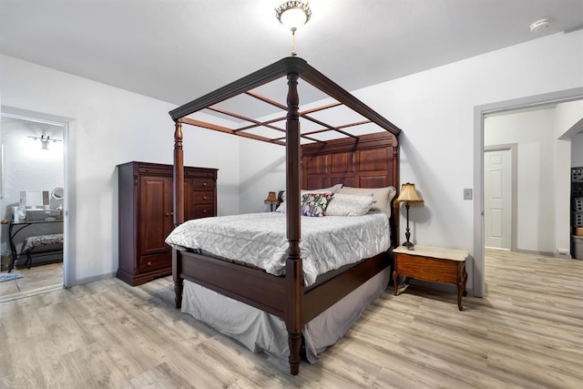 bedroom featuring baseboards and light wood-style floors