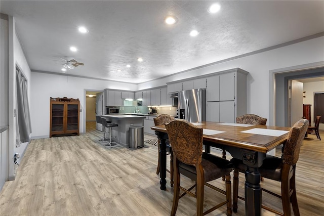 dining room with recessed lighting, light wood finished floors, a ceiling fan, and crown molding