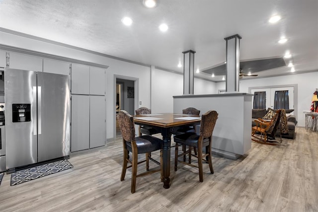 dining space with light wood-style flooring and recessed lighting