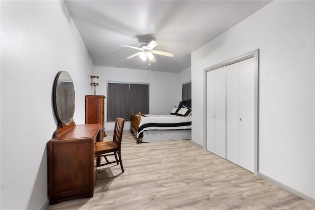 bedroom with light wood finished floors, a closet, baseboards, and ceiling fan
