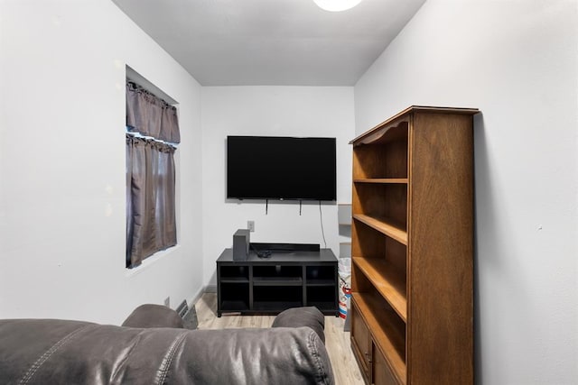 living room with light wood-type flooring and baseboards