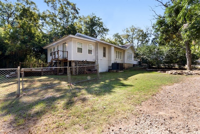 exterior space featuring a wooden deck, stairs, fence, and a lawn