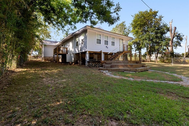 view of property exterior with a yard, a fenced backyard, a wooden deck, and stairway