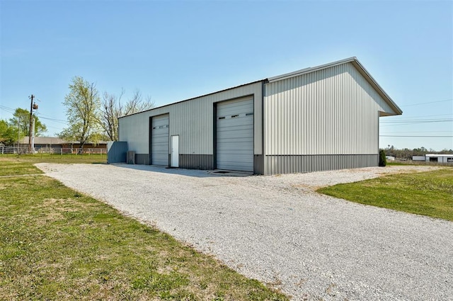 view of outdoor structure with an outbuilding and fence
