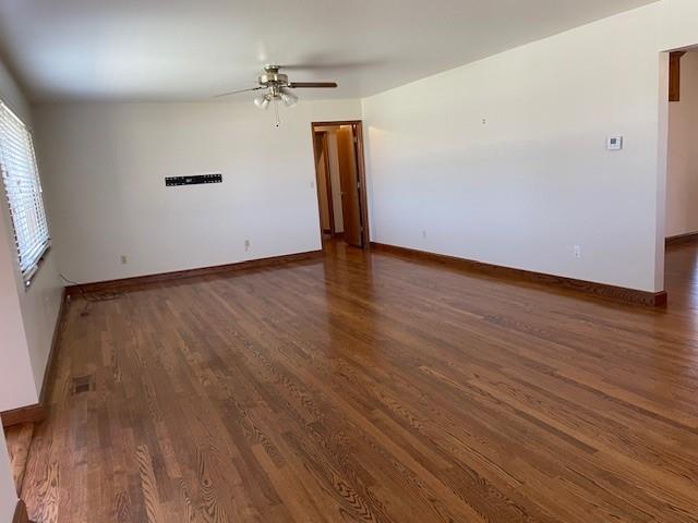 401 Memorial Dr, Okarche, OK 73762 - spare room with visible vents, ceiling fan, wood finished floors, and baseboards