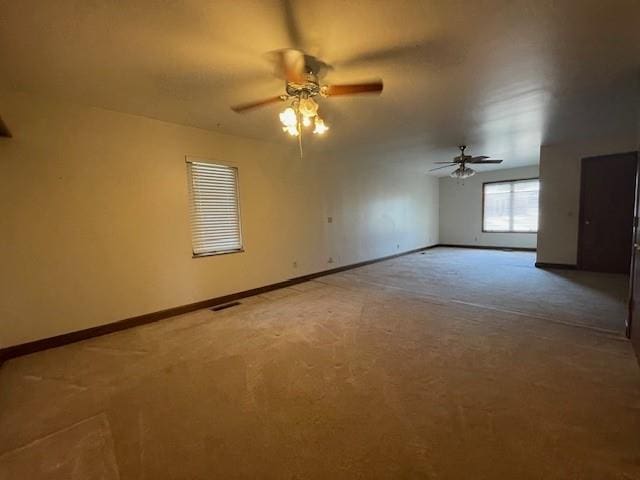 401 Memorial Dr, Okarche, OK 73762 - spare room with visible vents, baseboards, a ceiling fan, and carpet flooring