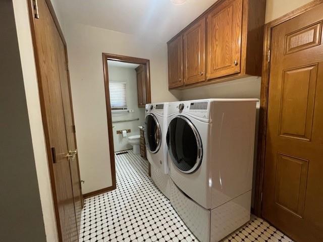 401 Memorial Dr, Okarche, OK 73762 - laundry area featuring washer and dryer and cabinet space