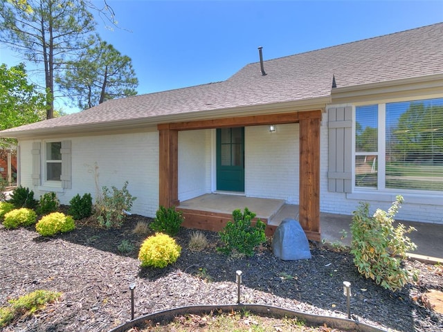 1804 Guilford Ln, Nichols Hills, OK 73120 - exterior space featuring brick siding, a porch, and roof with shingles