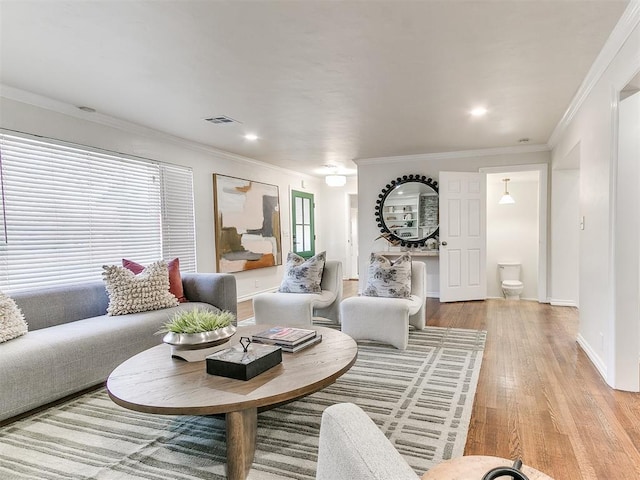 1804 Guilford Ln, Nichols Hills, OK 73120 - living room with ornamental molding, visible vents, baseboards, and light wood-style floors