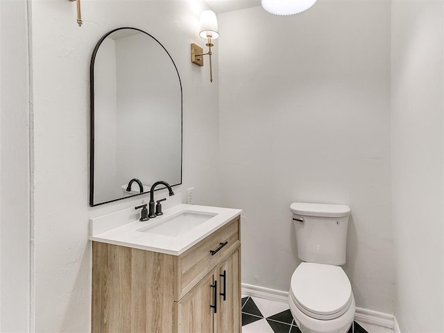 1804 Guilford Ln, Nichols Hills, OK 73120 - half bathroom featuring toilet, tile patterned flooring, baseboards, and vanity