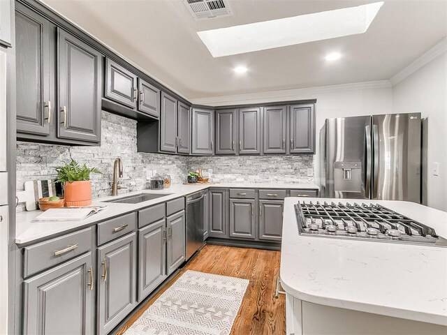 1804 Guilford Ln, Nichols Hills, OK 73120 - kitchen with ornamental molding, visible vents, appliances with stainless steel finishes, a sink, and gray cabinetry