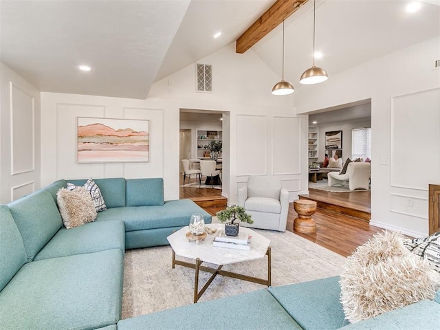 1804 Guilford Ln, Nichols Hills, OK 73120 - living area with a decorative wall, visible vents, recessed lighting, wood finished floors, and beam ceiling