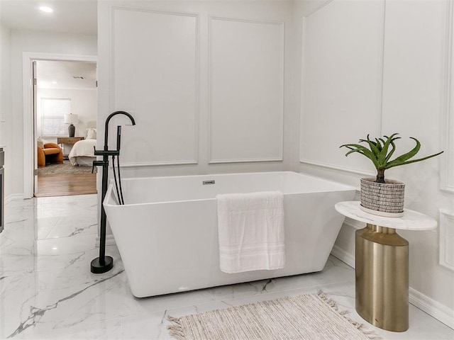 1804 Guilford Ln, Nichols Hills, OK 73120 - bathroom with a freestanding tub, marble finish floor, and baseboards