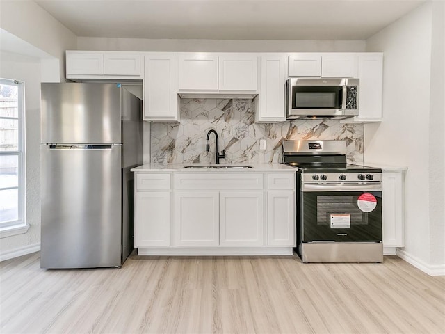 1804 Guilford Ln, Nichols Hills, OK 73120 - kitchen featuring baseboards, a sink, light countertops, white cabinetry, and stainless steel appliances