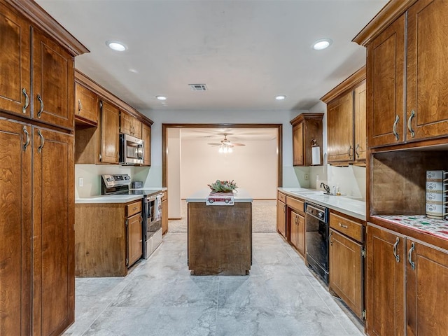 kitchen featuring visible vents, a sink, light countertops, stainless steel appliances, and a kitchen island