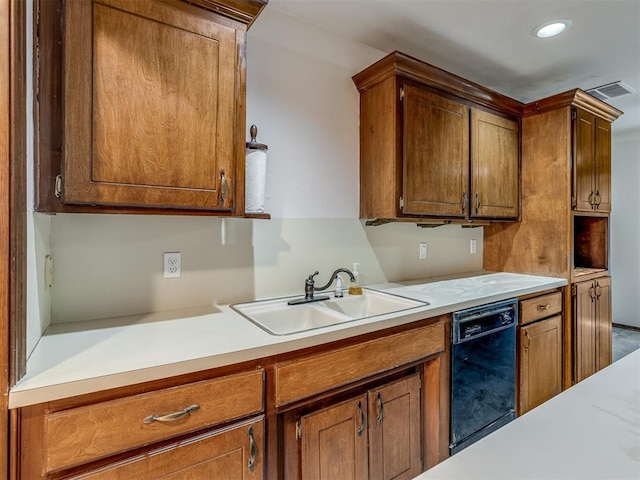 kitchen with light countertops, visible vents, brown cabinets, dishwasher, and a sink