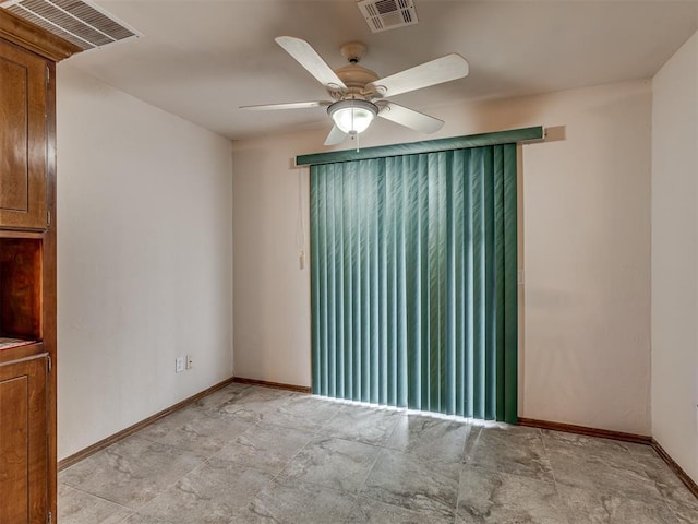 spare room with visible vents, baseboards, and a ceiling fan