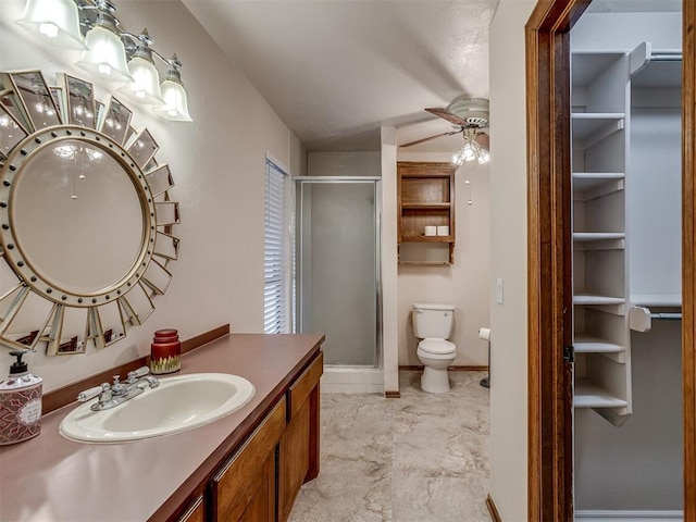full bath featuring ceiling fan, a shower stall, vanity, toilet, and baseboards