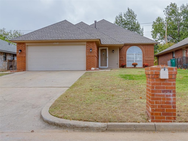 single story home with brick siding, a front yard, driveway, and a garage