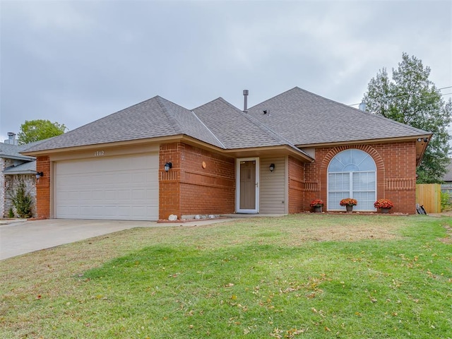 ranch-style home featuring concrete driveway, a front yard, brick siding, a garage, and a shingled roof