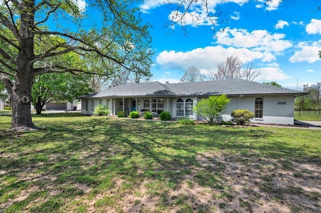 2315 Grisso Dr, Seminole, OK 74868 - ranch-style home featuring brick siding and a front lawn