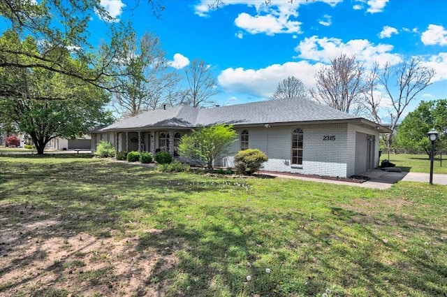 2315 Grisso Dr, Seminole, OK 74868 - view of side of home featuring brick siding, a yard, a garage, and concrete driveway