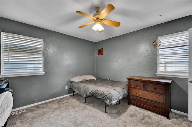 2315 Grisso Dr, Seminole, OK 74868 - bedroom with visible vents, baseboards, ceiling fan, carpet, and a textured wall