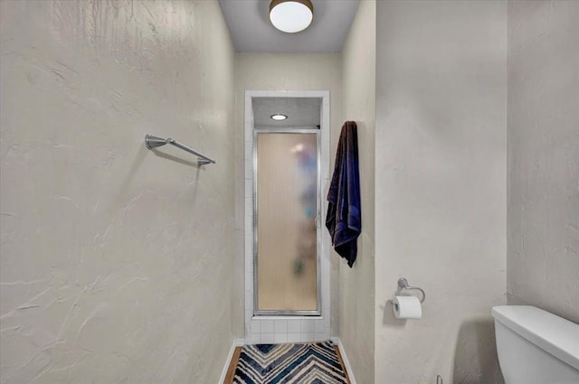 2315 Grisso Dr, Seminole, OK 74868 - full bathroom featuring a shower stall, baseboards, and toilet