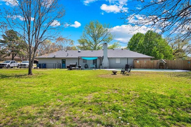 2315 Grisso Dr, Seminole, OK 74868 - rear view of property with a yard, a patio, fence, and a chimney