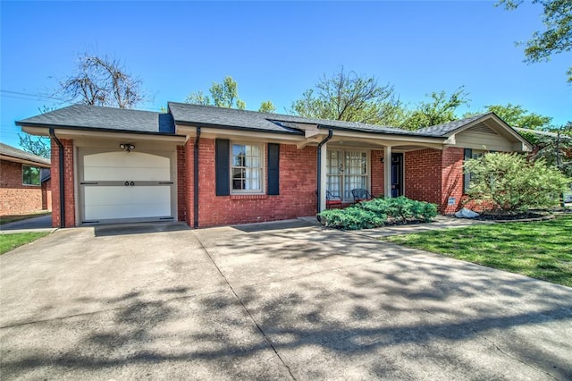 ranch-style house with an attached garage, concrete driveway, and brick siding